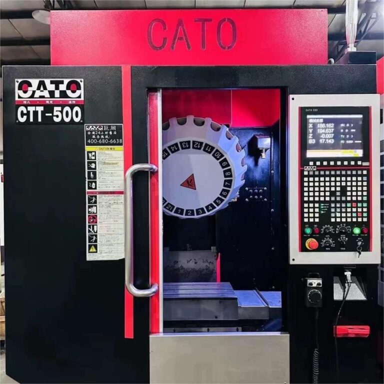 The CATO CTT-500 CNC Drill Tap Center is a precision machining tool designed for drilling, tapping, and other similar operations with high accuracy and efficiency. Here's a detailed description of the features commonly associated with the CATO CTT-500: CNC Control: Equipped with advanced CNC (Computer Numerical Control) technology, the CATO CTT-500 provides precise control over the machining process. This enables accurate positioning of cutting tools and ensures consistent and reliable results. High-Speed Spindle: The machine is likely outfitted with a high-speed spindle motor capable of rotating at various speeds to accommodate different materials and machining requirements. This feature allows for efficient drilling and tapping operations while maintaining quality and accuracy. Automatic Tool Changer: The CATO CTT-500 features an automatic tool changer system, enabling rapid tool changes during machining operations. This minimizes downtime and maximizes productivity by allowing for continuous workflow without manual intervention. Multi-Axis Machining: With multi-axis control capabilities, the CATO CTT-500 can simultaneously control multiple axes, providing versatility in machining complex geometries and achieving precise positioning of the workpiece. This enhances the machine's adaptability to diverse manufacturing tasks. Rigidity and Stability: Constructed with a robust and stable frame, the CATO CTT-500 minimizes vibrations during machining, ensuring high precision and surface finish quality. This rigidity also contributes to extended tool life and overall machine durability. User-Friendly Interface: The machine likely features an intuitive user interface that allows operators to easily program machining parameters, monitor the machining process, and make adjustments as needed. This user-friendly design enhances operator efficiency and productivity. Safety Features: Equipped with various safety features such as emergency stop buttons, protective enclosures, and safety interlocks, the CATO CTT-500 prioritizes operator safety and minimizes the risk of accidents during operation. Overall, the CATO CTT-500 CNC Drill Tap Center is a versatile and reliable machining solution suitable for a wide range of industries, including aerospace, automotive, and general manufacturing, where precision, efficiency, and quality are essential requirements. CATO CTT-500 CNC Drill Tap Center
